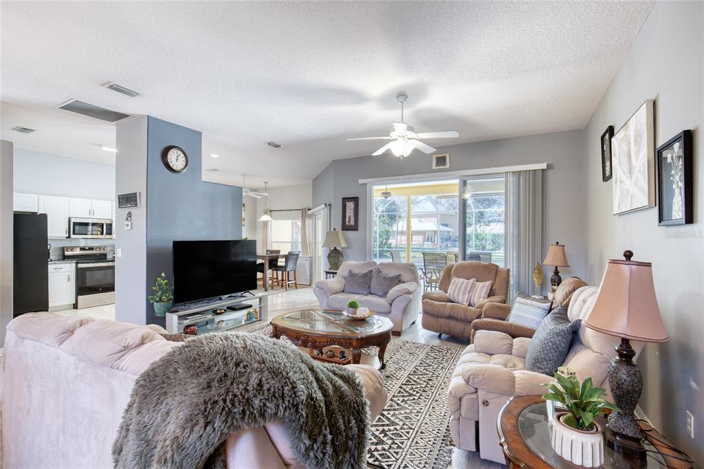 4 Cliffside Drive Ormond Beach, FL 32174 - Photo 21 of 65 a living room with furniture a flat screen tv and a large window