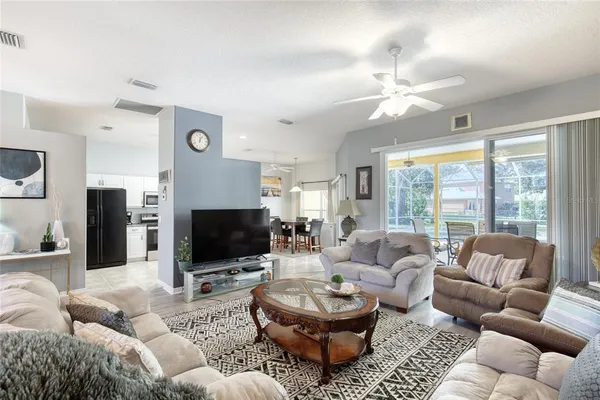 a kitchen with granite countertop a refrigerator stove and microwave