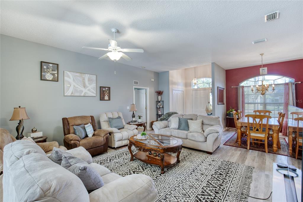 4 Cliffside Drive Ormond Beach, FL 32174 - Photo 26 of 65 a living room with furniture and a chandelier