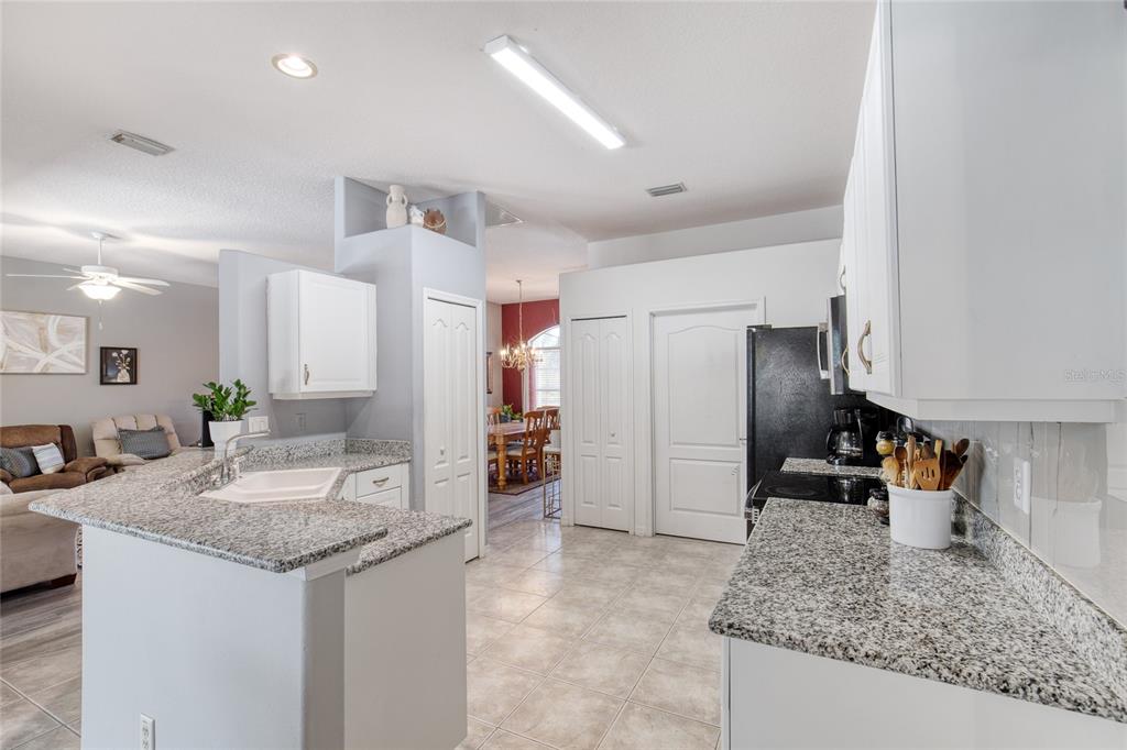4 Cliffside Drive Ormond Beach, FL 32174 - Photo 30 of 65 a kitchen with stainless steel appliances granite countertop a sink stove and refrigerator