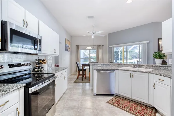 a dining room with furniture and a floor to ceiling window