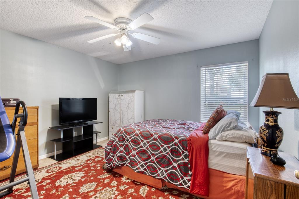 4 Cliffside Drive Ormond Beach, FL 32174 - Photo 33 of 65 a bedroom with a bed and a flat tv screen on the dresser