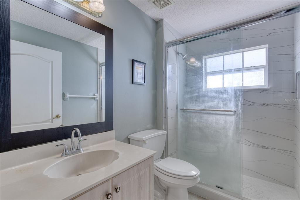 4 Cliffside Drive Ormond Beach, FL 32174 - Photo 35 of 65 a bathroom with a sink toilet and shower