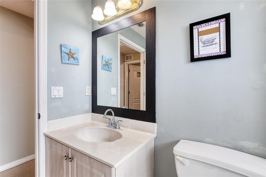 4 Cliffside Drive Ormond Beach, FL 32174 - Photo 36 of 65 a bathroom with a toilet a sink and mirror