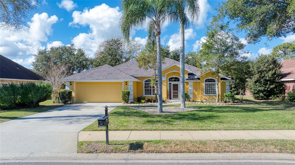 4 Cliffside Drive Ormond Beach, FL 32174 - Photo 49 of 65 a front view of a house with a yard and garage