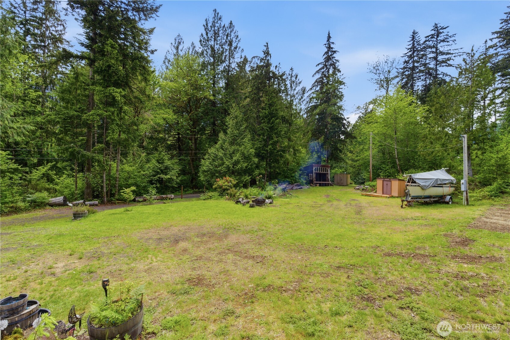 3320 Duckabush Road Brinnon, WA 98320 - Photo 31 of 38 a view of a yard with a house in the background