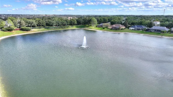 a view of a hallway with wooden floor and furniture