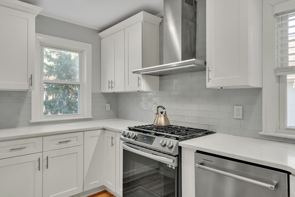 33 Avon Road Wellesley, MA 02482 - Photo 13 of 35 a kitchen with white cabinets and a stove top oven