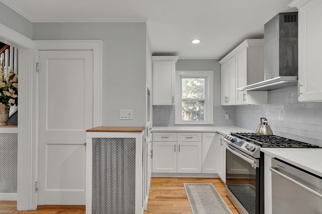 33 Avon Road Wellesley, MA 02482 - Photo 14 of 35 a kitchen with stainless steel appliances granite countertop a sink and a stove