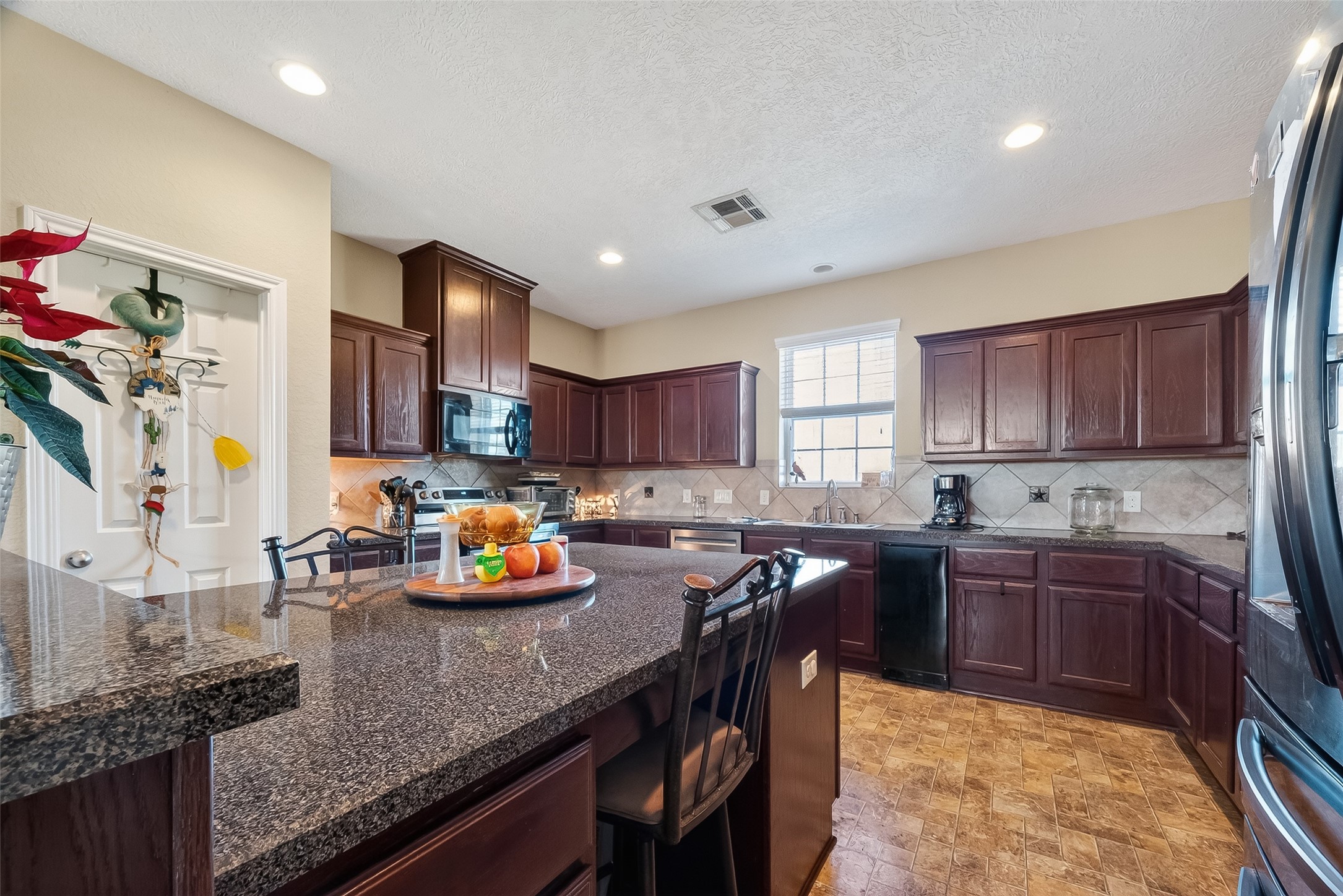 3418 Barbers Hill Road Highlands, TX 77562 - Photo 21 of 50 a kitchen with stainless steel appliances granite countertop counter space a sink and cabinets