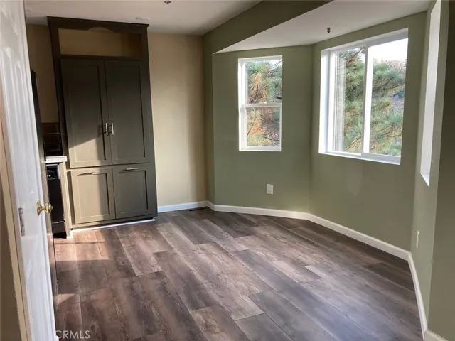 a kitchen with a refrigerator and a stove top oven