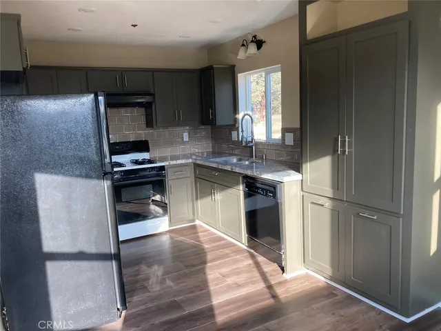 a kitchen with granite countertop wooden cabinets and stainless steel appliances