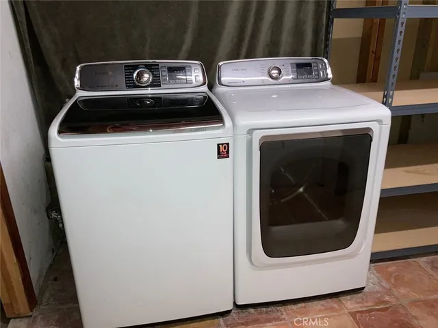 a view of a yard with wooden fence