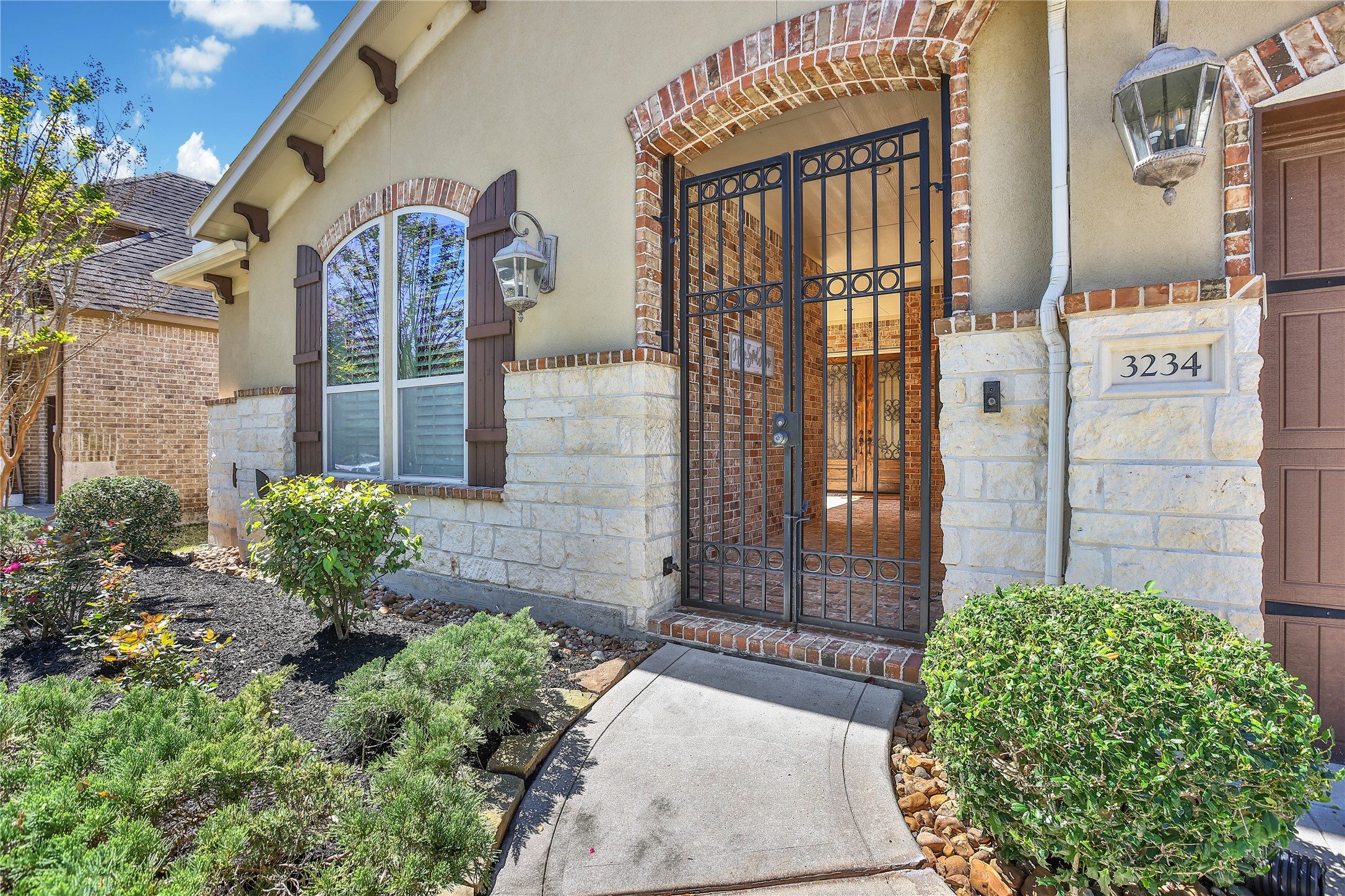 3234 Explorer Way Conroe, TX 77301 - Photo 5 of 46 Welcome guests through the gated courtyard and elegant front entry, setting the tone for this exceptional home.