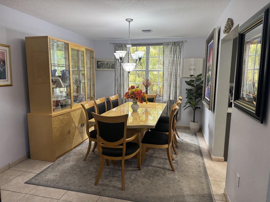 12353 Natalies Cove Road Cooper City, FL 33330 - Photo 11 of 24 a view of a dining room with furniture window and outside view