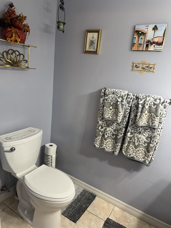 12353 Natalies Cove Road Cooper City, FL 33330 - Photo 12 of 24 a white toilet sitting next to a bathroom sink