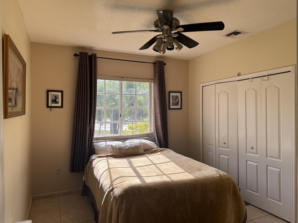12353 Natalies Cove Road Cooper City, FL 33330 - Photo 20 of 24 a bedroom with a large bed and a window