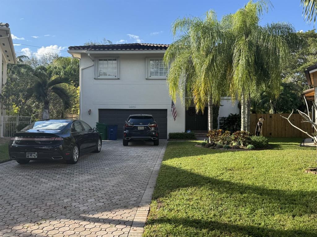 12353 Natalies Cove Road Cooper City, FL 33330 - Photo 2 of 24 a view of a car parked in back yard of a house