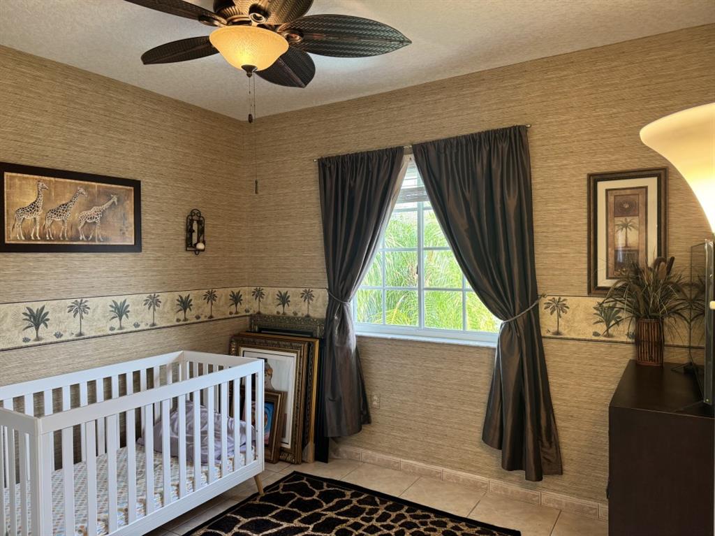 12353 Natalies Cove Road Cooper City, FL 33330 - Photo 21 of 24 a bedroom with furniture and a window