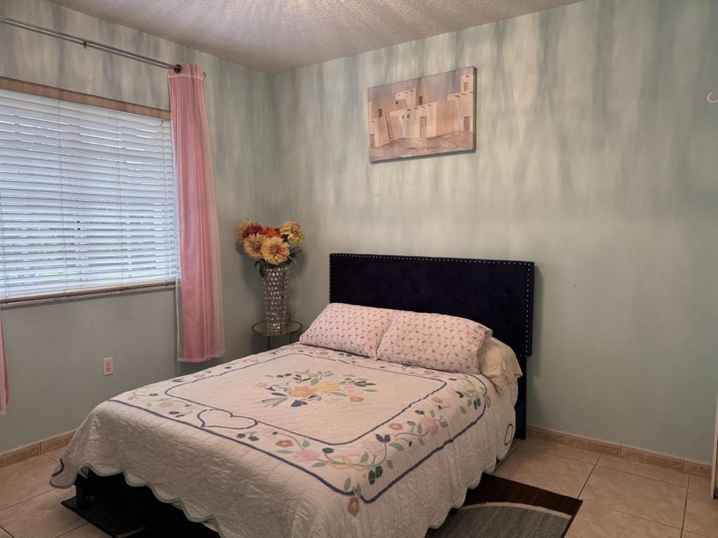 12353 Natalies Cove Road Cooper City, FL 33330 - Photo 22 of 24 a bedroom with a bed and painting on the wall