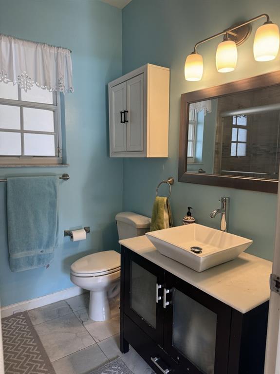 12353 Natalies Cove Road Cooper City, FL 33330 - Photo 23 of 24 a bathroom with a sink a toilet and a mirror