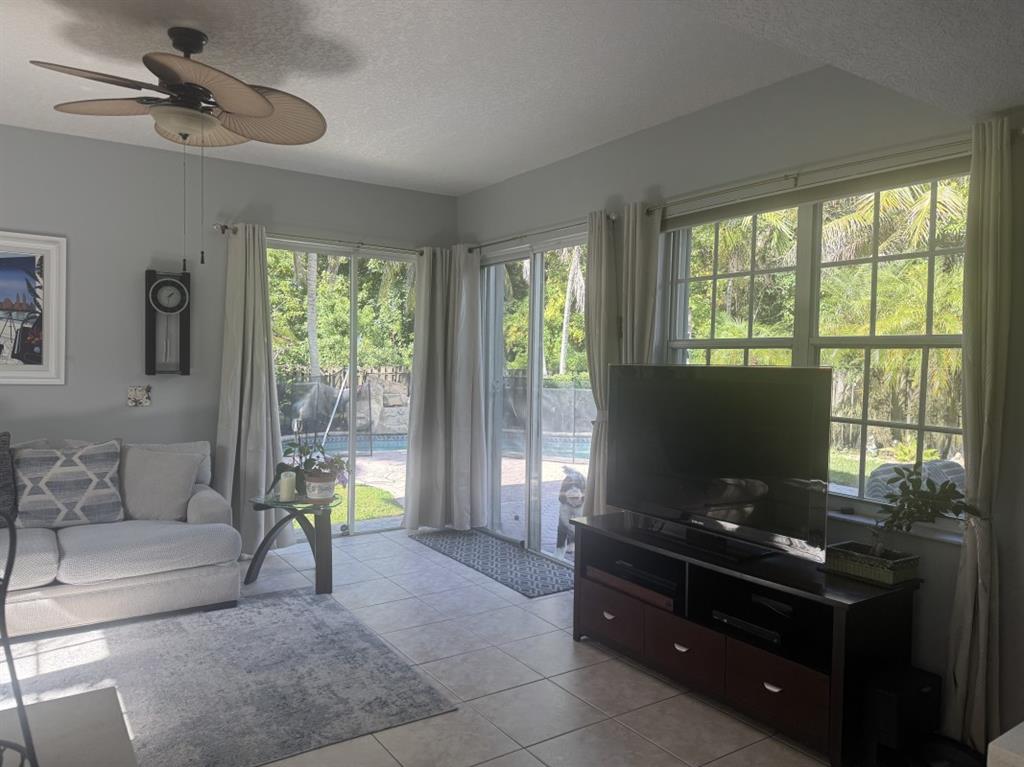 12353 Natalies Cove Road Cooper City, FL 33330 - Photo 7 of 24 a living room with furniture and a flat screen tv