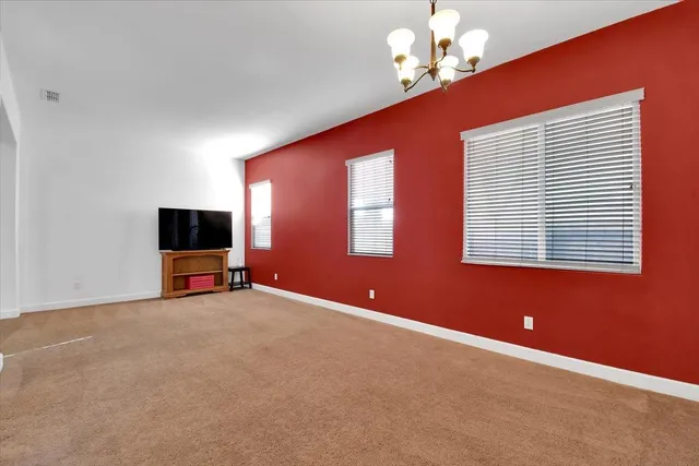 a living room with furniture a large window and a flat screen tv
