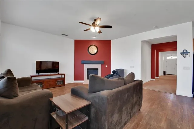 a living room with furniture a fireplace and a large window
