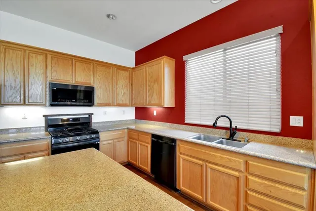 a stove top oven sitting inside of a kitchen