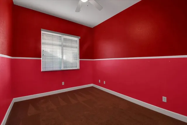 a view of a hallway with a chandelier fan and a livingroom