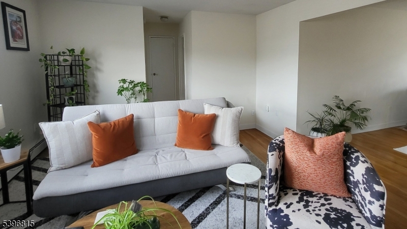 2467 Highway 10, Unit 8B Morris Plains, NJ 07950 - Photo 2 of 15 a living room with furniture and flowers