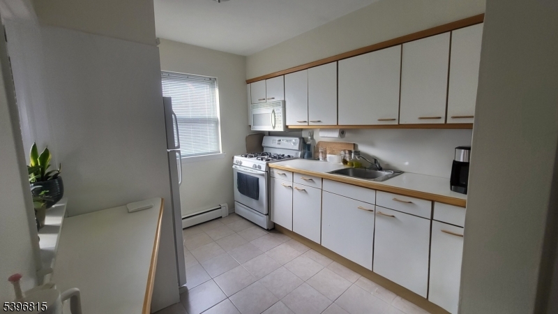 2467 Highway 10, Unit 8B Morris Plains, NJ 07950 - Photo 3 of 15 a kitchen with white cabinets and white appliances
