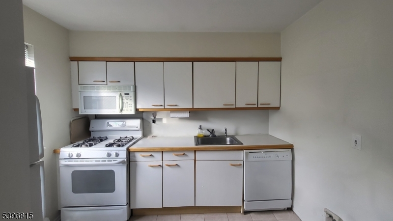 2467 Highway 10, Unit 8B Morris Plains, NJ 07950 - Photo 4 of 15 a kitchen with cabinets appliances and a sink