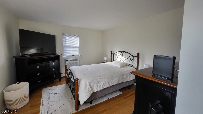 2467 Highway 10, Unit 8B Morris Plains, NJ 07950 - Photo 10 of 15 a bedroom with a bed and a flat screen tv