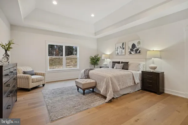 a spacious bedroom with a bed and a window