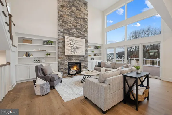 a living room with furniture wooden floor and a fireplace