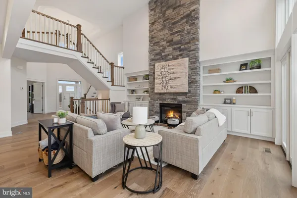 a living room with furniture a rug and a fireplace