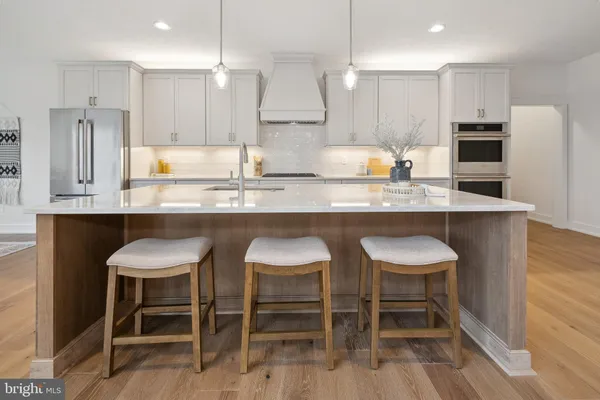 a kitchen with granite countertop cabinets a table and chairs in it