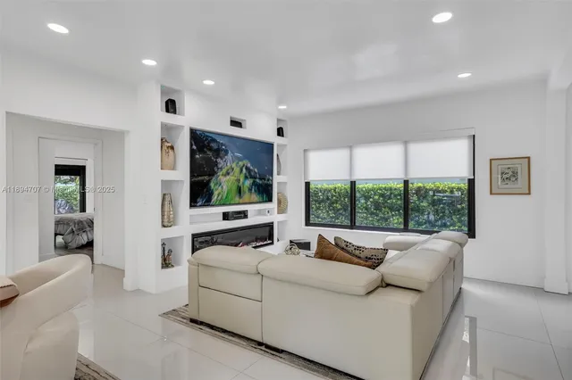 a living room with furniture a large window