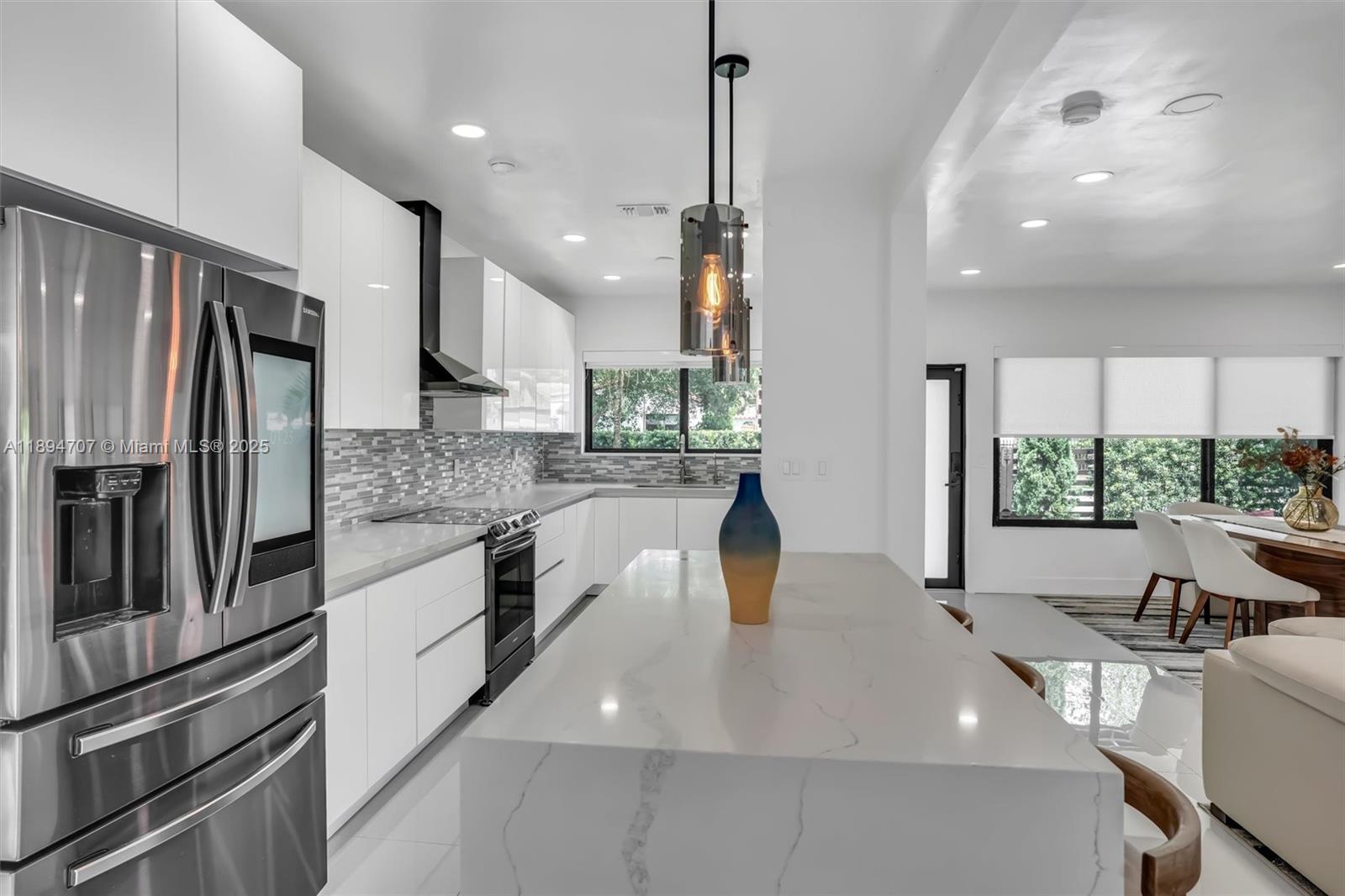 2484 Southwest 25th Street Miami, FL 33133 - Photo 24 of 53 a kitchen with stainless steel appliances granite countertop a sink a stove and a refrigerator