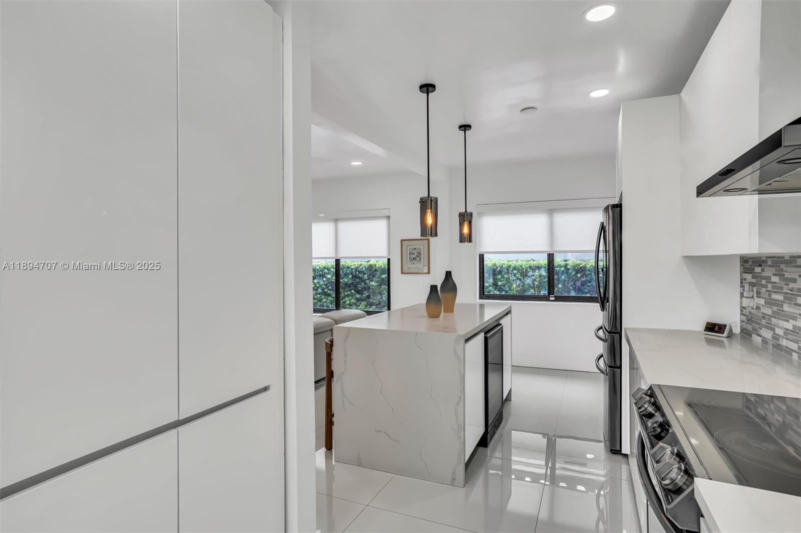 2484 Southwest 25th Street Miami, FL 33133 - Photo 29 of 53 a view of kitchen with stainless steel appliances granite countertop refrigerator sink and wooden floor