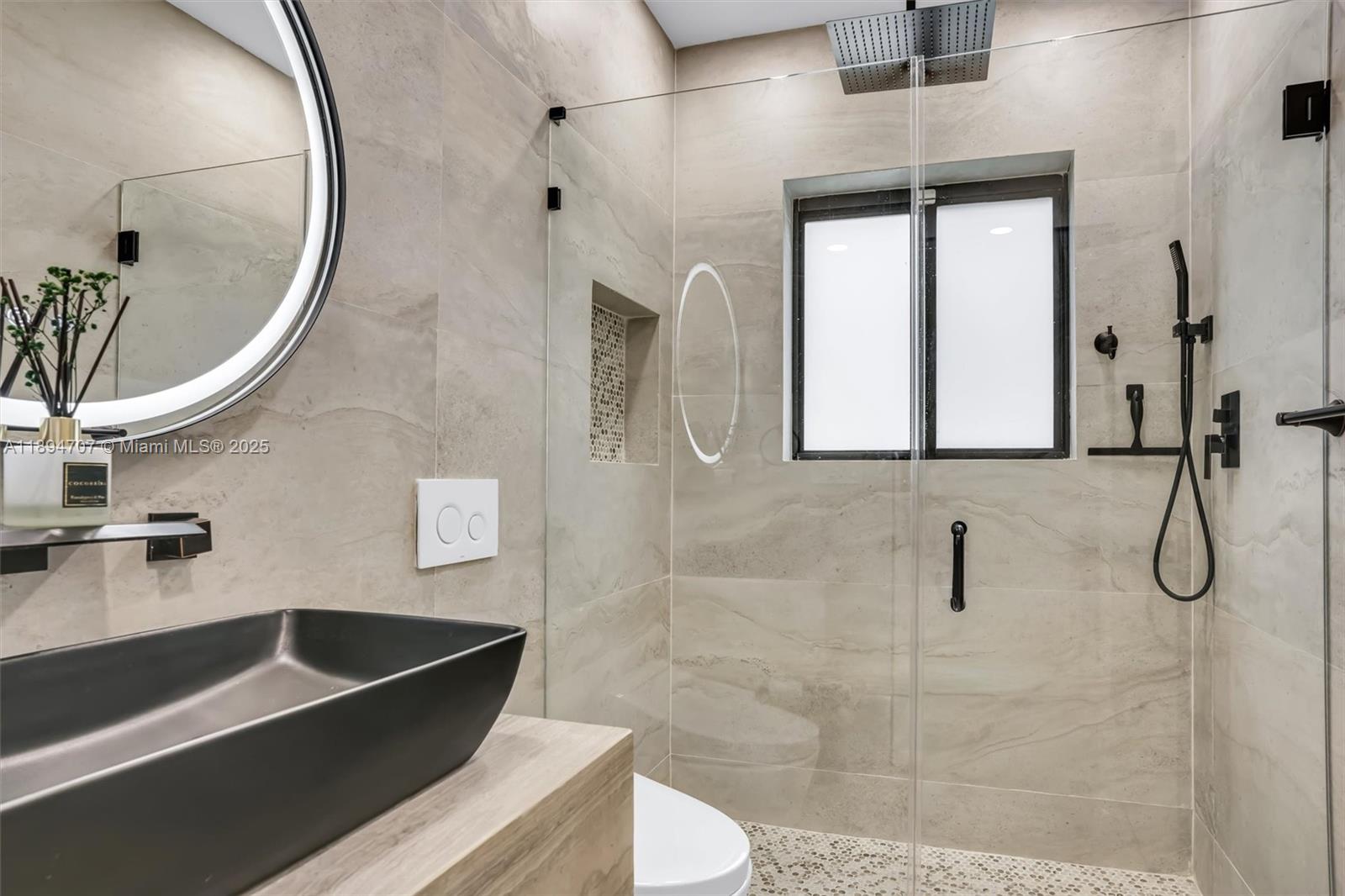 2484 Southwest 25th Street Miami, FL 33133 - Photo 40 of 53 a bathroom with a sink a toilet and shower