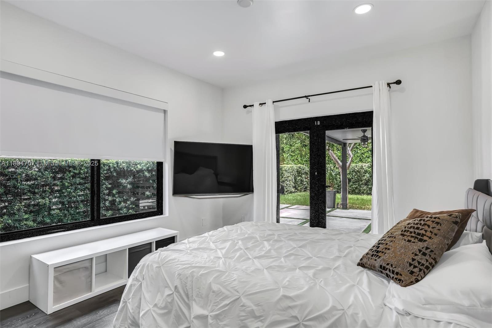 2484 Southwest 25th Street Miami, FL 33133 - Photo 41 of 53 a bedroom with a bed and a television