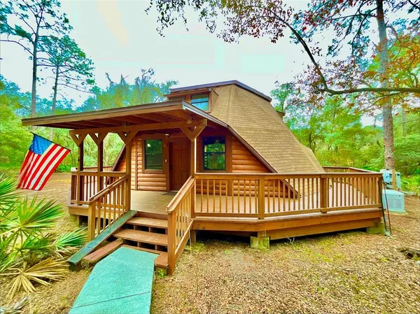 a view of a yard with wooden deck and furniture