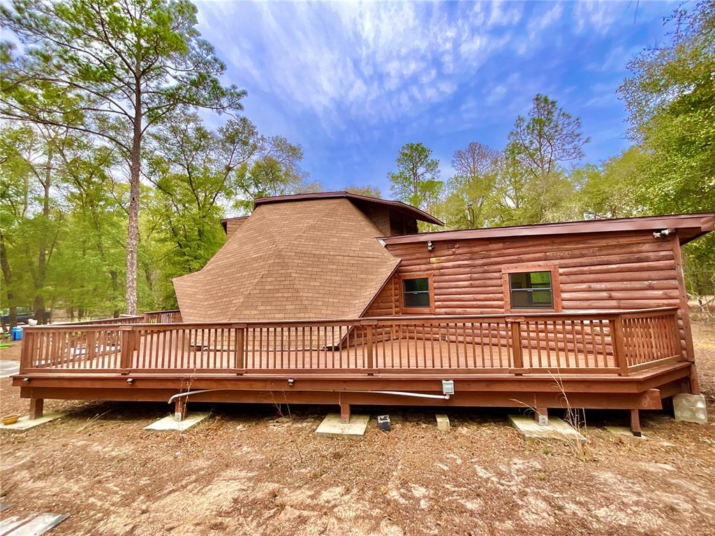 141 Tucker Lake Road Melrose, FL 32666 - Photo 28 of 29 a view of a house with a wooden deck and a yard