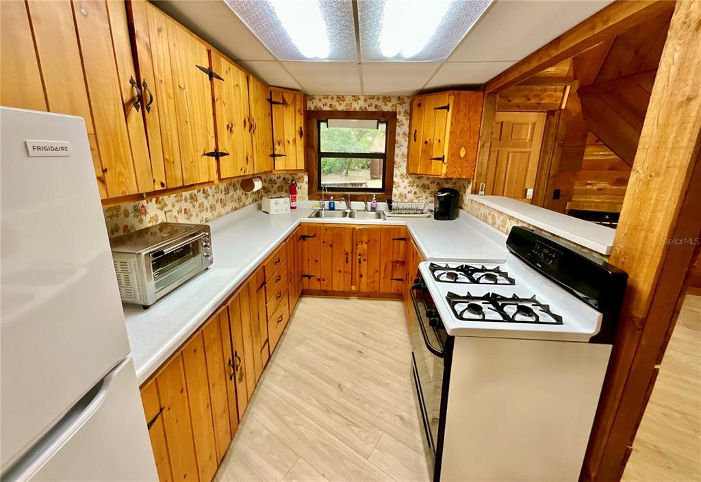 141 Tucker Lake Road Melrose, FL 32666 - Photo 8 of 29 a kitchen with sink a stove and cabinets