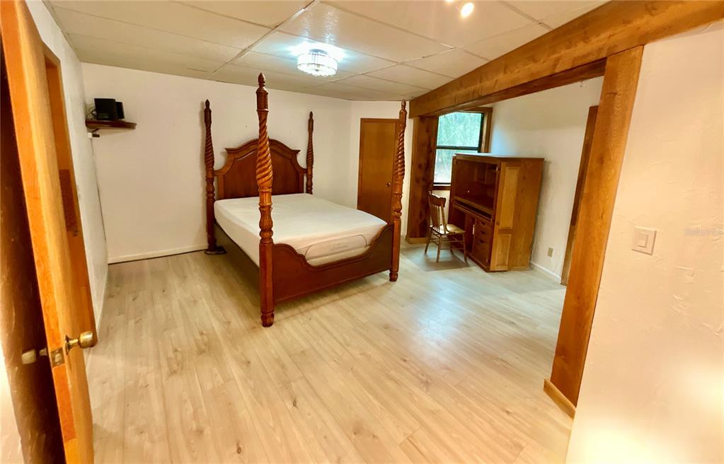 141 Tucker Lake Road Melrose, FL 32666 - Photo 9 of 29 a bedroom with a bed and wooden floor