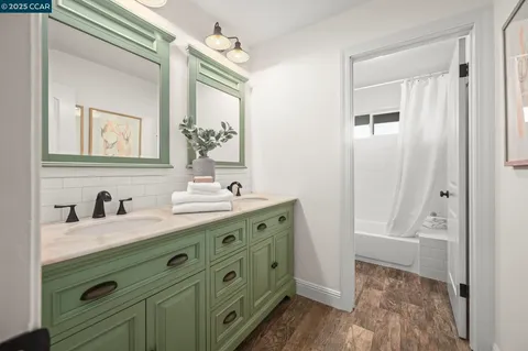 a bathroom with a double vanity sink a mirror and a