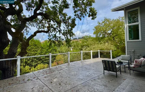 a view of a chairs and table in the backyard