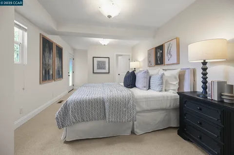 a bedroom with a bed and a night stand